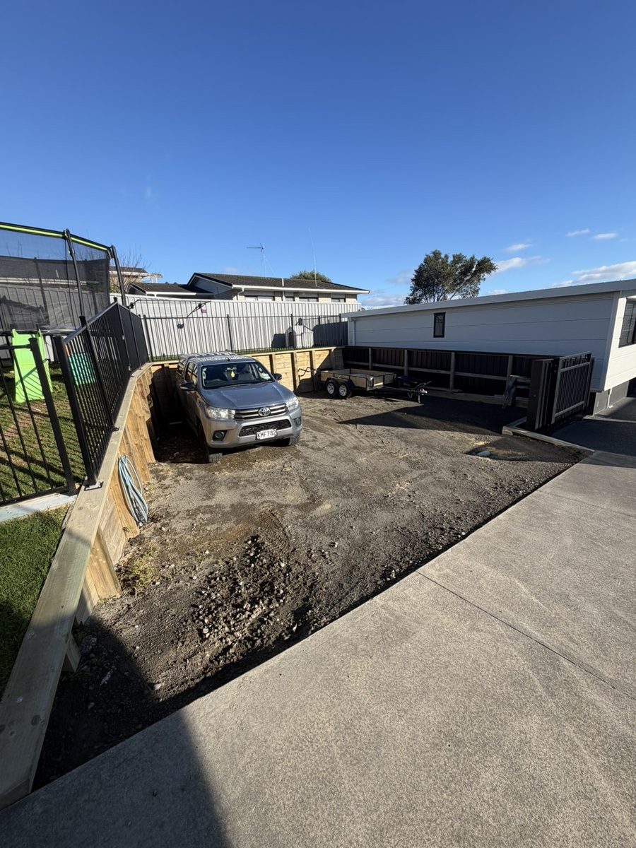 Before: concrete parking area replacing a dirt yard
